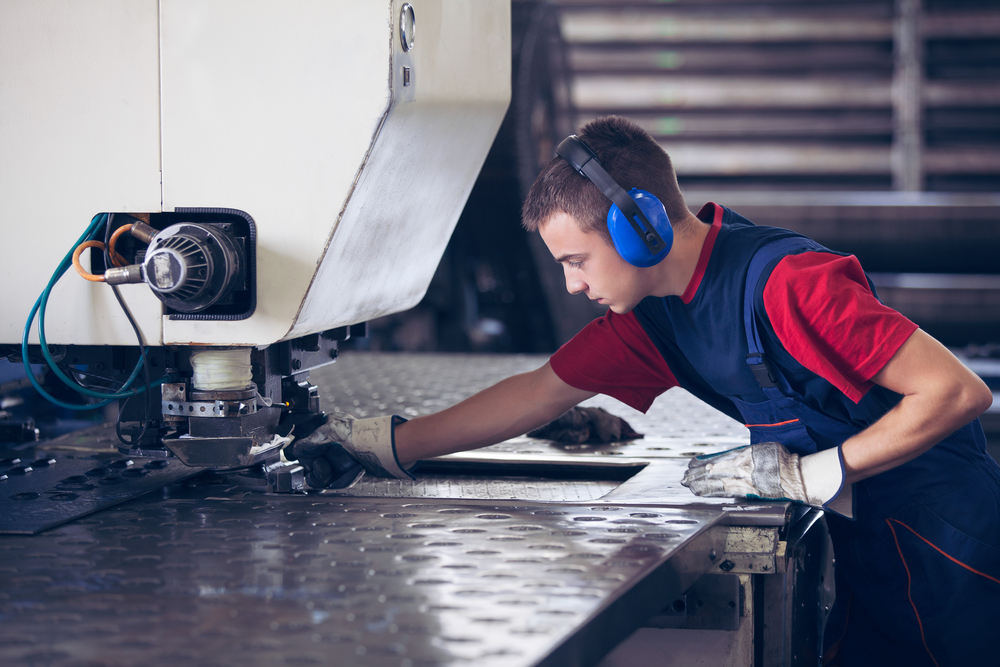 Inside,A,Factory,,Industrial,Worker,In,Action,On,Metal,Press