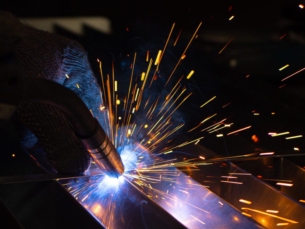 Worker using Oxyacetylene gas to weld in sheet metal factory